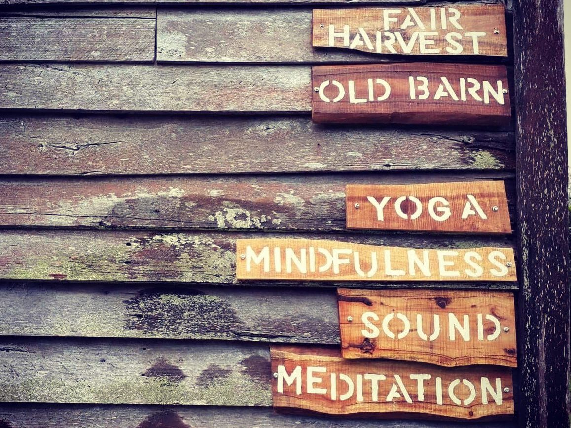 Wooden signs: Fair Harvest, Yoga, Meditation