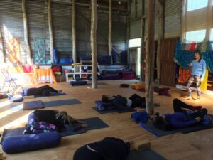 Yoga class in cosy, rustic studio with instructor.