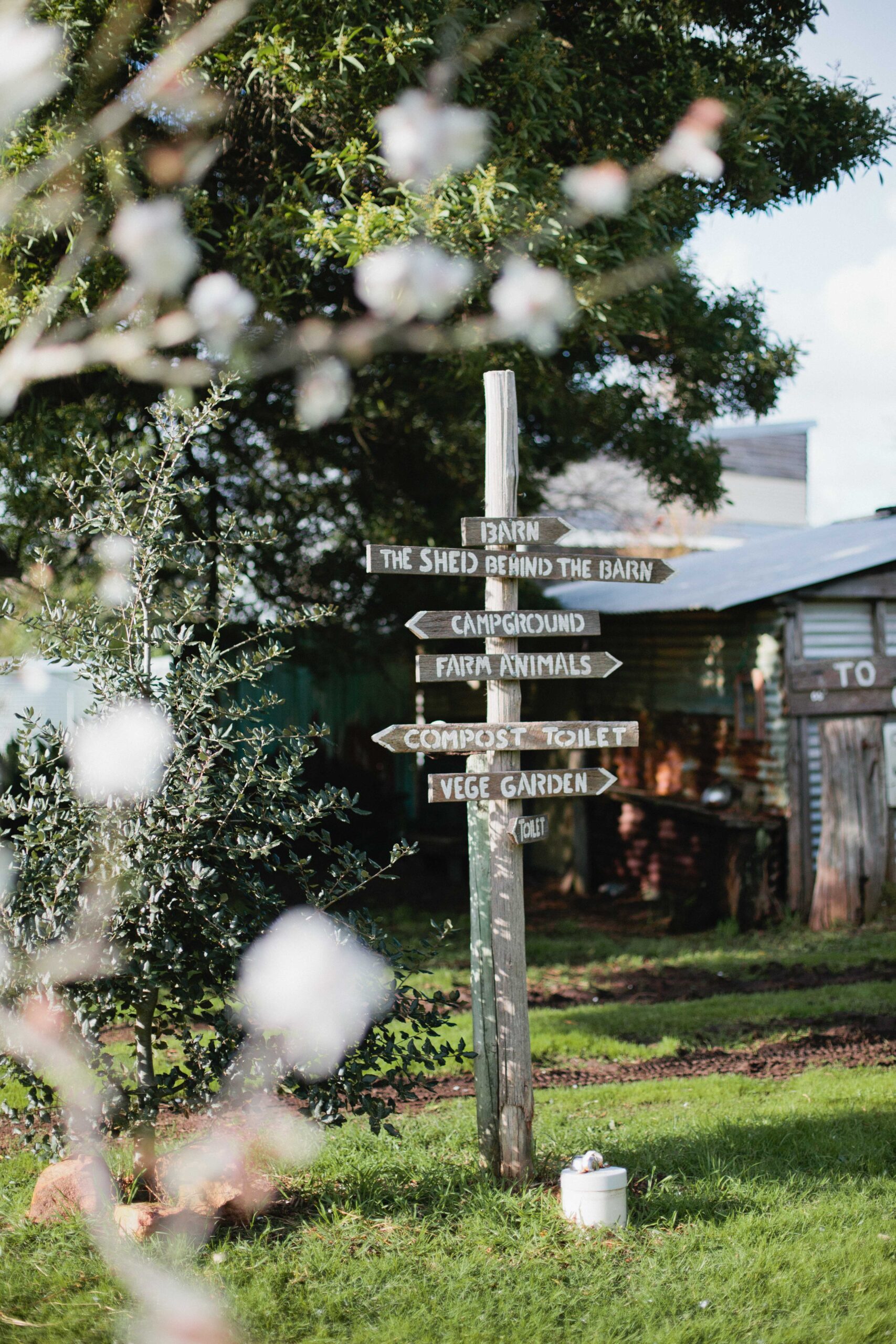Rustic signpost with multiple farm directions.