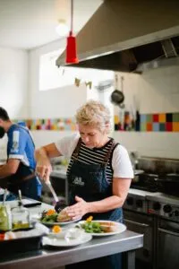 Woman preparing food in a professional kitchen