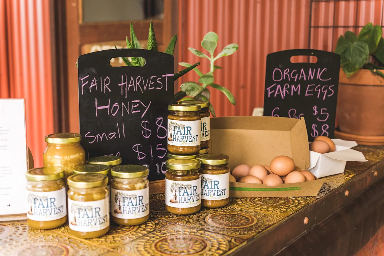 Local honey and eggs display at market stall.
